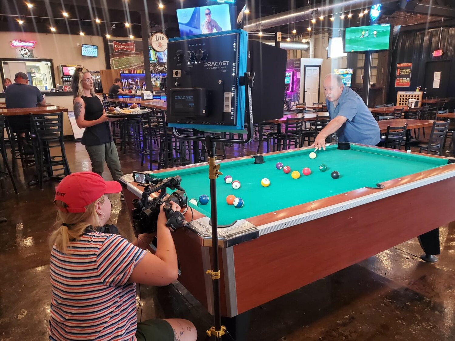 Stripes or solids? Ozarks Live co-host Tom Trtan lines up shot playing eight-ball pool at KC’s Sports Bistro on Washington Avenue.