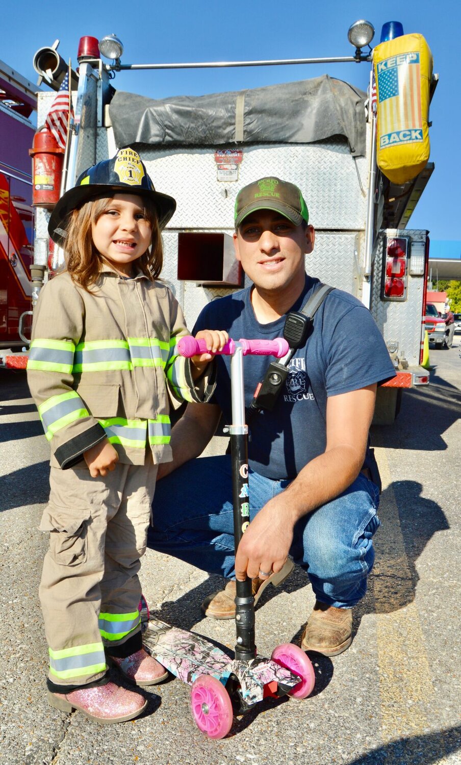 Kaesyn Meltesen, 4 when this photo was taken, took part in the 2022 Howell County Fire Engine Rally dressed out in her own personalized gear and sparkly pink boots. She is the daughter of Howell Rural Fire District No. 1 firefighter Kevin Meltesen, shown with her, and Howell County 911 employee Kalli Meltesen. This year’s festivities will take place Oct. 7 in the parking lot of the Greater Ozarks Center for Advanced Technology, 395 E. Broadway in West Plains. All in the community are invited.