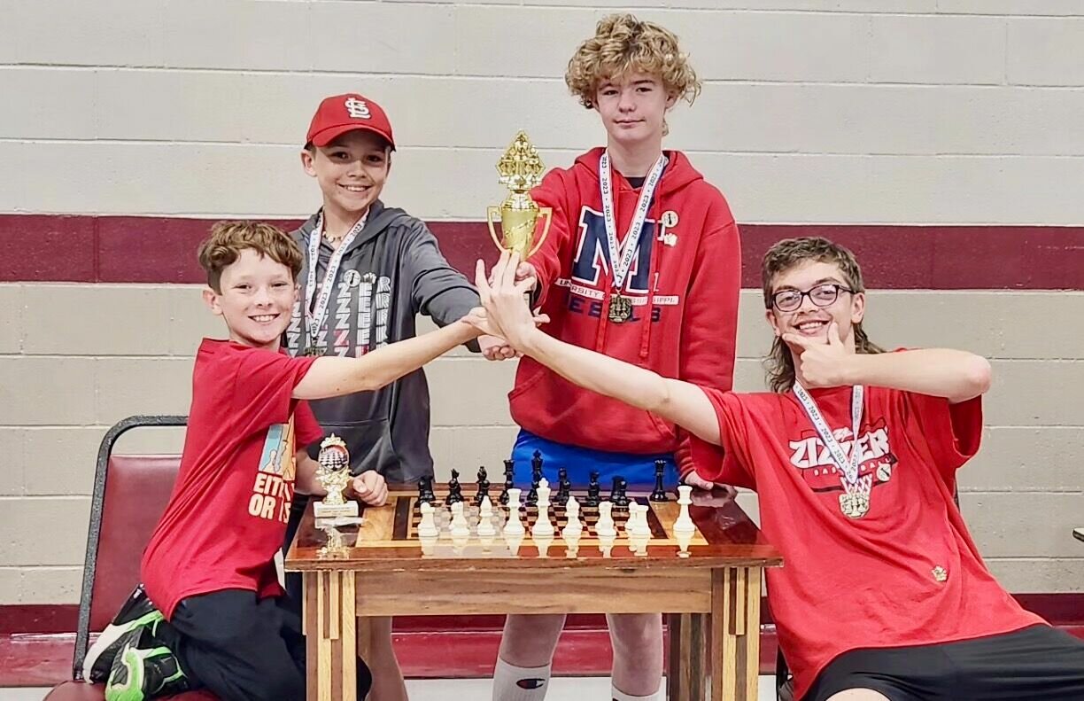 The West Plains Middle School Chess Team took home a second place trophy from a recent tournament. From left, the quartet of Jack Casebeer, Asa McFarland, Chaz Coats and Isaac Brucker collectively earned a team score of 9.5, just two points behind first place winner Willow Springs Middle School, which had eight players: Sebastian Puher, Otto Schuette, Ayden Bennett, Wyatt Barker, Heidi Bennett, Kane Bennett, Maximus Layton and Maxson Becker. Casebeer, a sixth grader, also took home a medal for second place in individual scores. With 4 points even, he came just shy of the 4.5 score achieved by Asher Salt of Mtn. Grove.