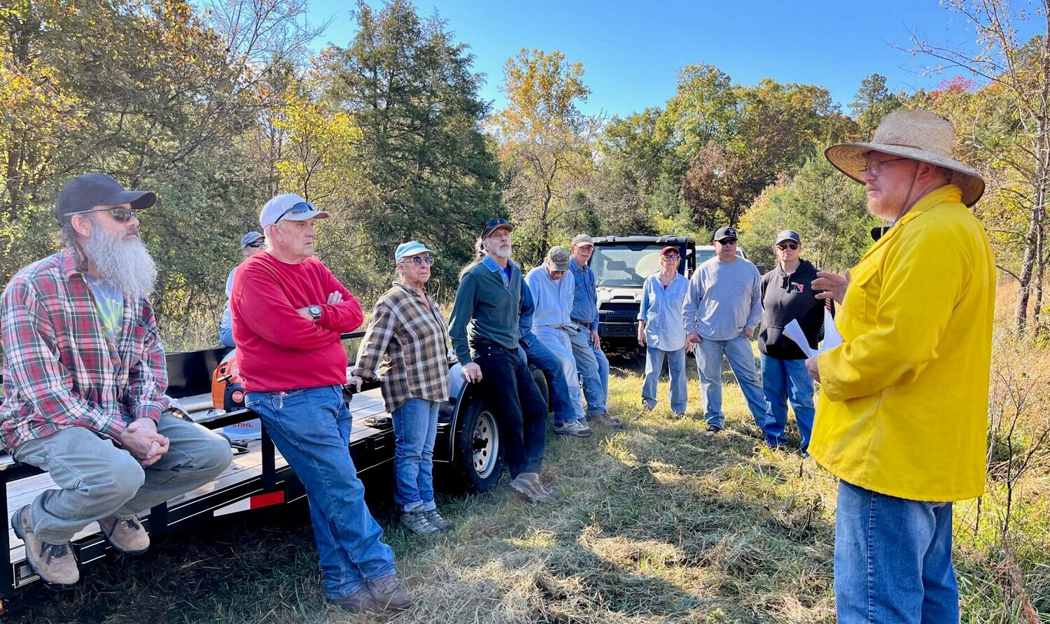 Prescribed fire workshop participants listen while Missouri Department of Conservation Private Land Conservationist Mark McLain, far right, explains how to use drip torches and leaf blowers during controlled fires.