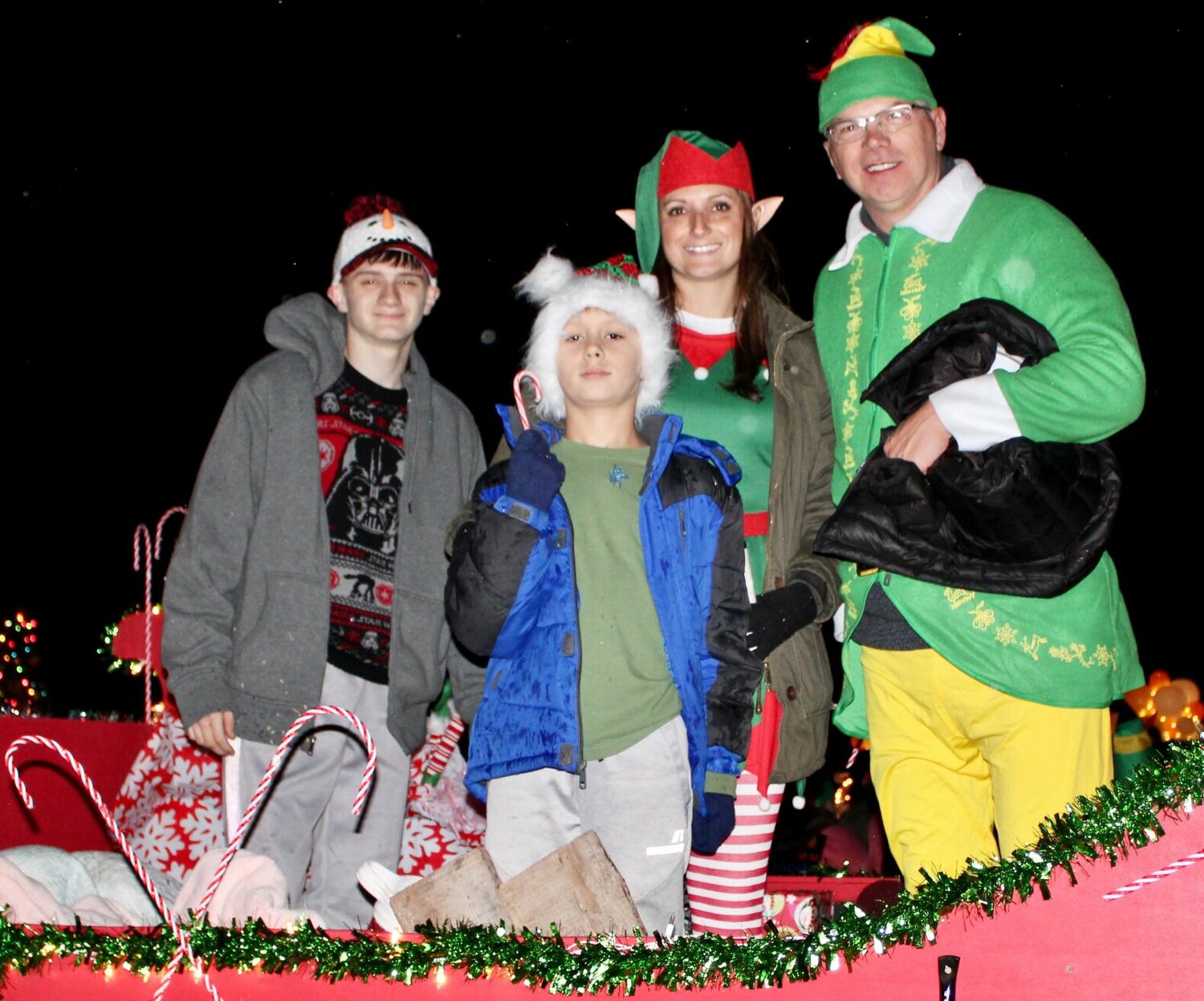 Buddy the Elf and friends were represented on this Willow Springs Chamber of Commerce float, making spirits bright despite cold drizzle that started at the beginning of the parade. The parade, themed "Christmas at the Movies," was held Saturday evening as the finale of a day's worth of Christmas activities in downtown Willow Springs. From left are Jace Rogers, Paxton Tooley, Brittney Collins and Robert Hollis.