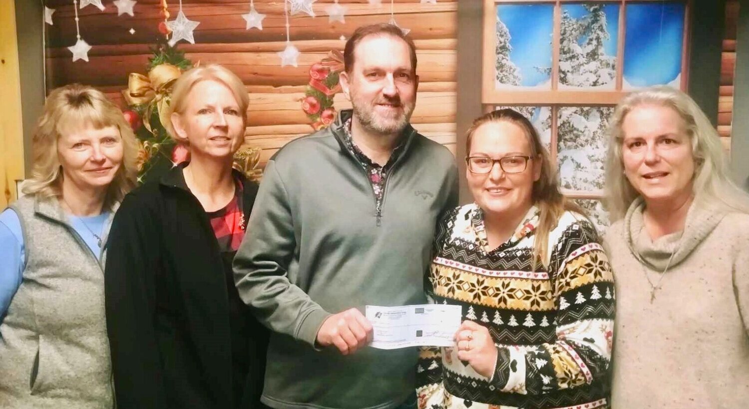 On Nov. 30, Ozark Independent Living donated $500 to Christos House to help provide Christmas gifts to families staying at the organization's emergency domestic and sexual violence shelter. "We are grateful for the generous contribution from Ozark Independent Living," said Interim Christos House Shelter Supervisor Amanda Wade. "This will go a long way to help the families staying with us have a good Christmas." From left: Ozark Independent Living employees Lori Cox, Shelley Surface and Executive Director John Adamson; Wade; and Christos House Interim Executive Director Kelli Neel.